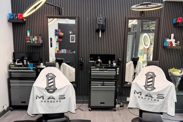 A chair and mirror at M.A.S Barbers
